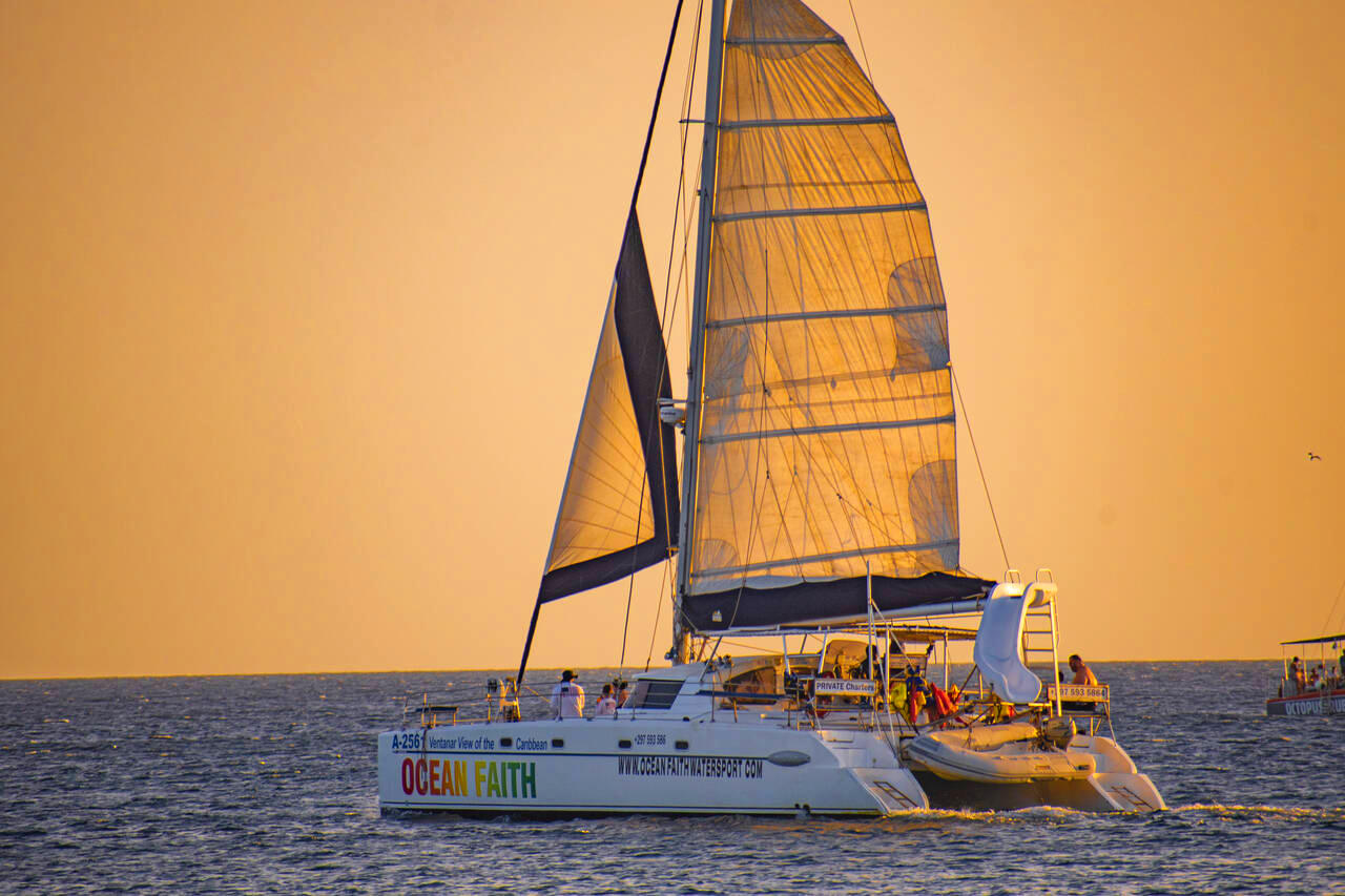 Sailing Catamaran "Ocean Faith" setting out for an Aruba Sunset Cruise